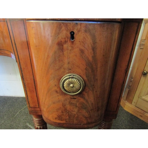 1018 - A Regency mahogany sideboard, shaped front with two central drawers and a pair of convex drawers on ... 