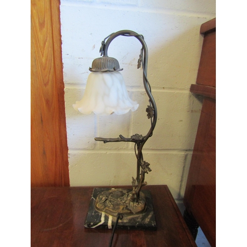 1019 - A bronze effect tree form table lamp with frilled shade on black marble base