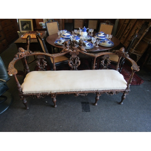 1027 - A 19th Century walnut ornate three seater settee, carved cherubs and mask detail, for re-covering, l... 