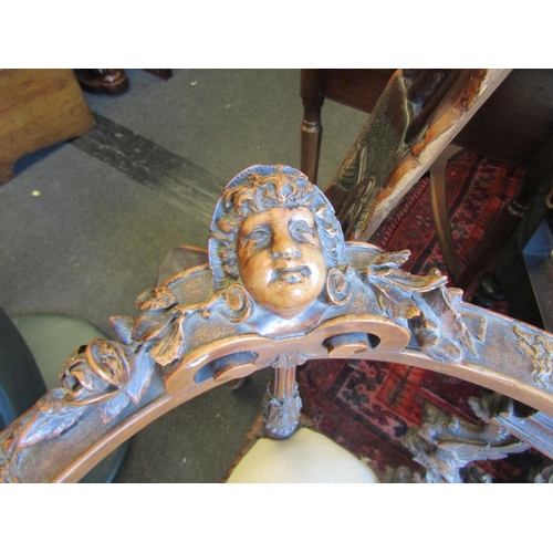 1027 - A 19th Century walnut ornate three seater settee, carved cherubs and mask detail, for re-covering, l... 