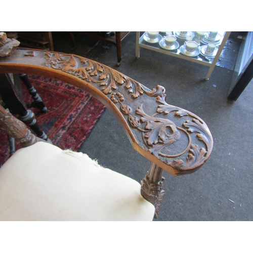 1027 - A 19th Century walnut ornate three seater settee, carved cherubs and mask detail, for re-covering, l... 