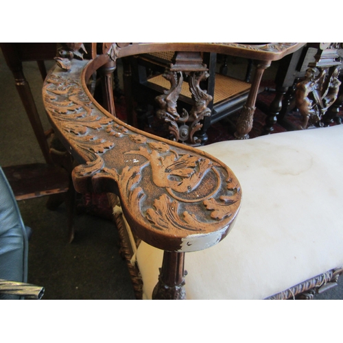 1027 - A 19th Century walnut ornate three seater settee, carved cherubs and mask detail, for re-covering, l... 