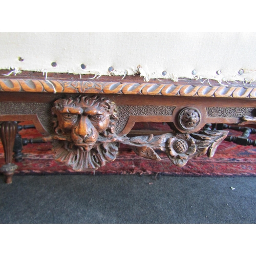 1027 - A 19th Century walnut ornate three seater settee, carved cherubs and mask detail, for re-covering, l... 