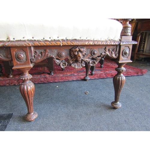 1027 - A 19th Century walnut ornate three seater settee, carved cherubs and mask detail, for re-covering, l... 