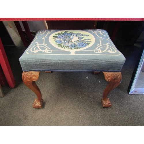 1053 - A carved walnut stool, tapestry fabric, cabriole legs with ball in claw feet