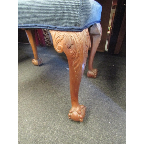 1053 - A carved walnut stool, tapestry fabric, cabriole legs with ball in claw feet