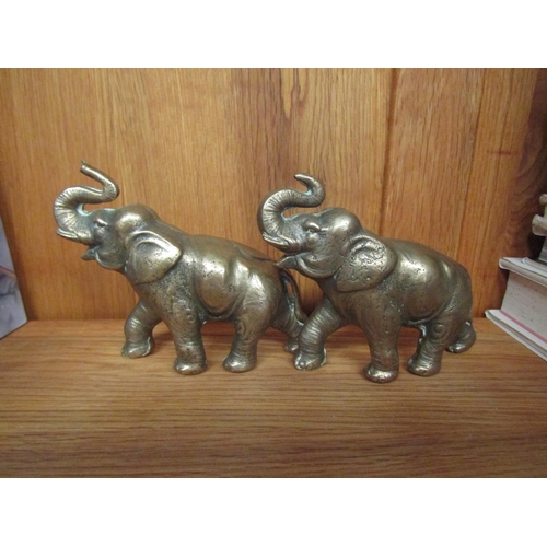 1054 - A pair of heavy brass elephant figures, 10cm tall