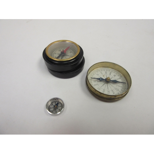 1370 - A compass in bakelite case and a similar example together with a miniature compass (3)