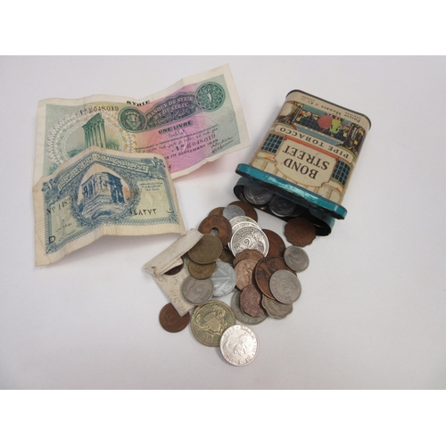 1376 - A Bond Street pipe tobacco tin with miscellaneous coinage to include a 1986 £2 coin, Foreign bank no... 