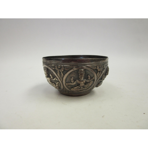 1429 - An Indian white metal bowl with deity panels, 6.5cm diameter