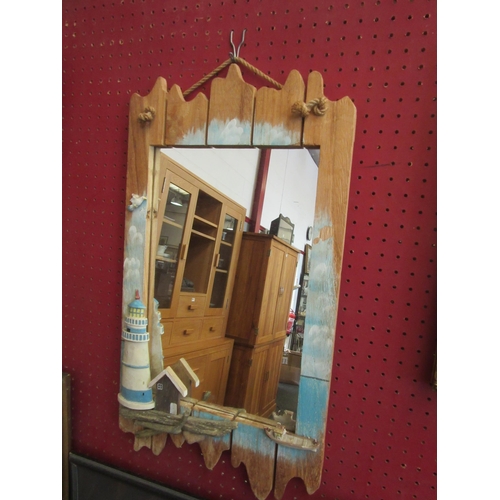 1071 - A driftwood mirror applied with lighthouse, hut and row boat (mirror plate 38cm x 25cm)