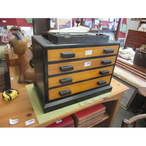 1092 - A Deco style ebonised hardwood chest of four long drawers containing geometry instruments and a Merc... 