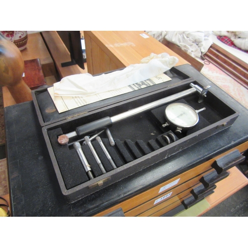 1092 - A Deco style ebonised hardwood chest of four long drawers containing geometry instruments and a Merc... 