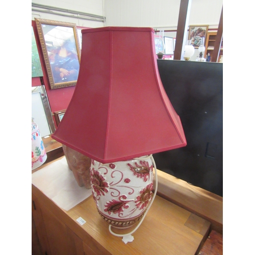 1099 - A large table lamp base with relief of red flowers, red shade