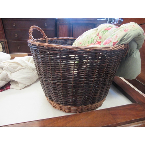 1116 - A wicker twin handled log basket, 52cm diameter