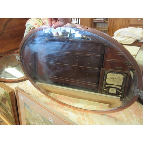 1125 - A copper framed bevel edge oval hanging mirror together with another (2)