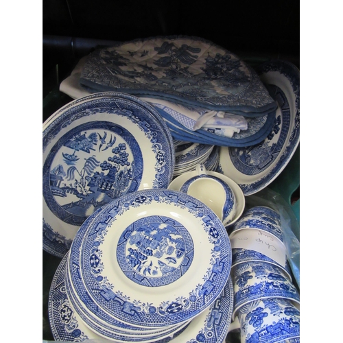 1158 - Two boxes of blue and white ceramics, mainly Willow pattern including tea cosy and place mats