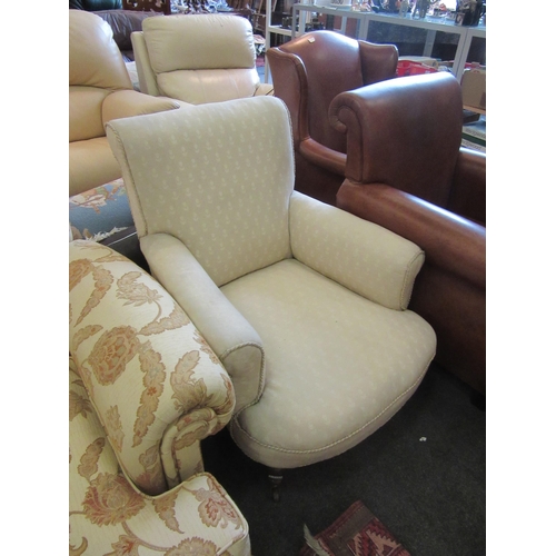 1174 - A Victorian deep seated armchair, cream foliate upholstery