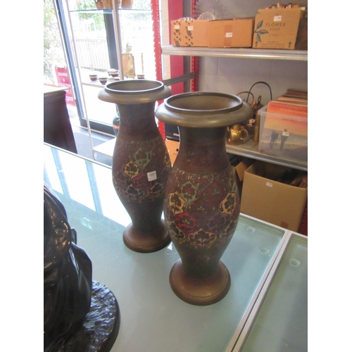 1221 - A pair of Eastern enamelled brass vases, 25cm tall