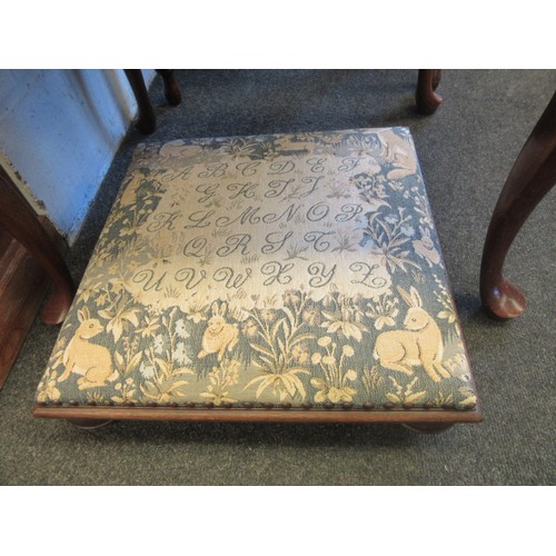 1040 - A Simon Simpson footstool with alphabet and wildlife tapestry on castors