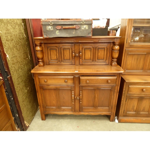 2343 - An Ercol elm court cupboard