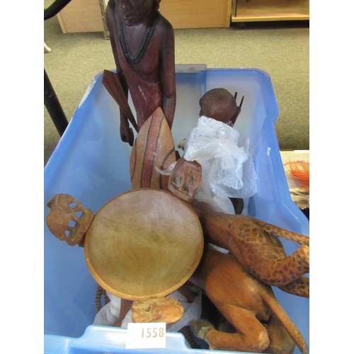 1558 - A box of assorted African carvings including wooden tripod-legged bowl, warrior statue etc.