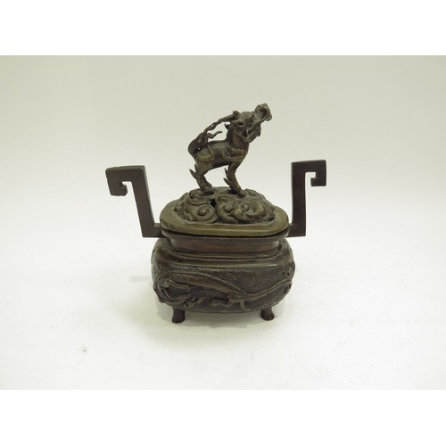 6706 - A bronze censor, the lid surmounted by a dragon dog, 13.5cm x 13cm