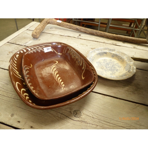 2011 - Two glazed slipware dishes, one cracked and a blue and white plate