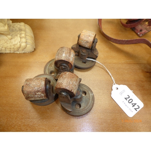 2042 - Four 19th Century iron and wooden roller castors by AK and Son's