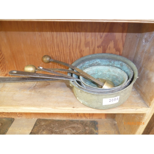 2058 - A set of three copper pans and two shoe or toe lasts