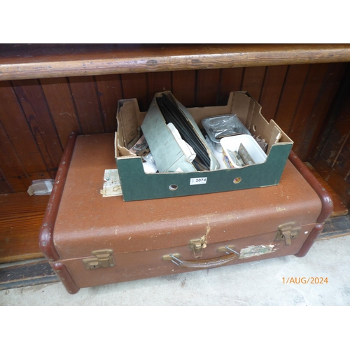 2074 - A box of mixed brass hinges, hooks etc and a vintage case