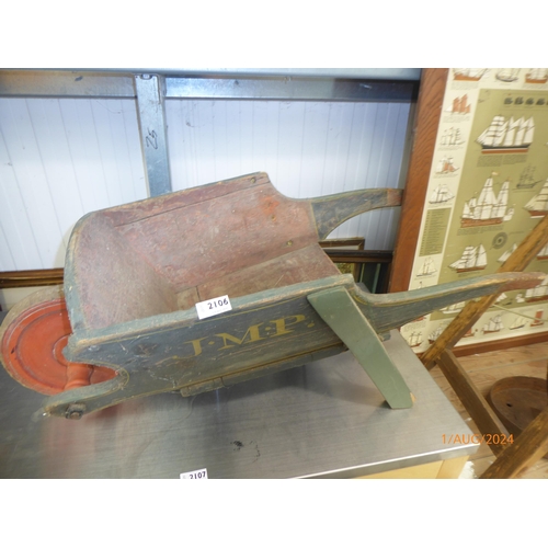 2106 - A small childs wheelbarrow with initials J.M.P