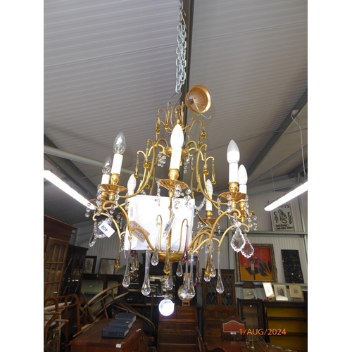 2122 - A gilt metal eight arm electrolier with glass droplets