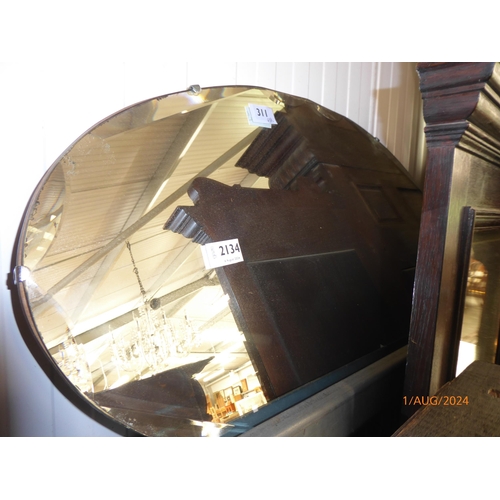 2134 - An oak framed mirror with an art deco oval mirror