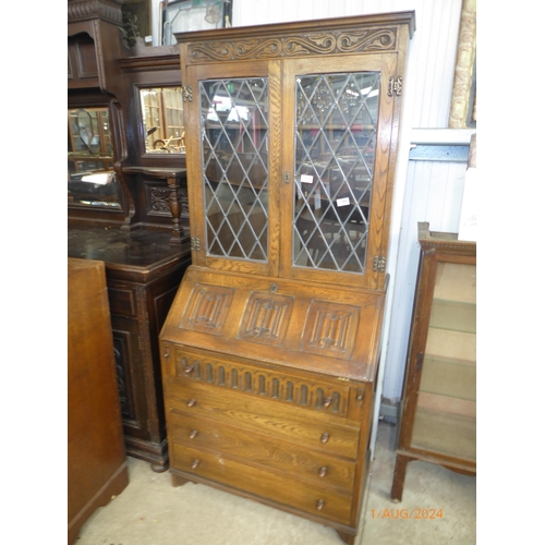 2141 - An oak linen fold bureau bookcase