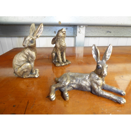 2150 - Three miniature resin bronze hares