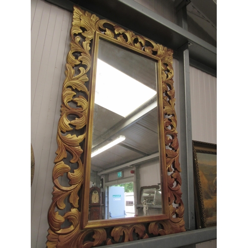 2164 - A gilt framed decorative mirror. 121cm x 70cm