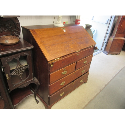 2176 - A Georgian oak bureau with fitted interior and secret well