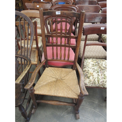 2203 - An early 19th century Lancashire spindle back rocking chair with rush seat