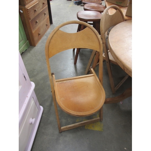 2314 - A pair of folding bent ply beech chairs