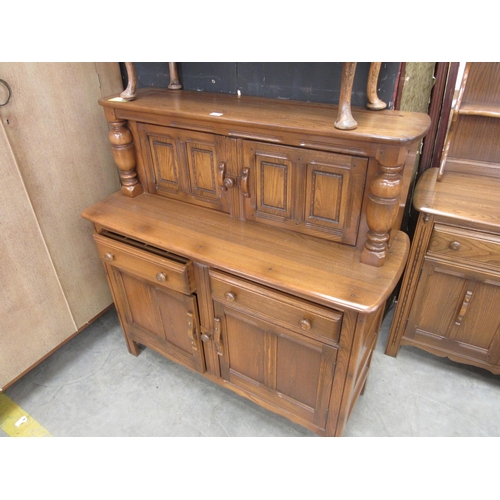 2343 - An Ercol elm court cupboard