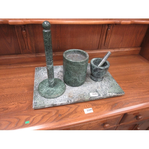 2345 - A green stone kitchen set including a cutting board, mortar & pestle and a kitchen roll holder