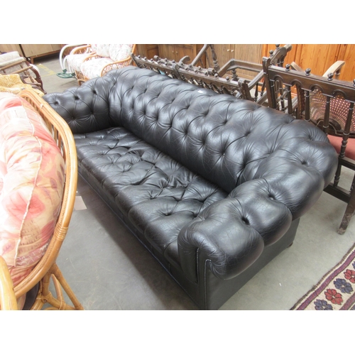 2362 - A deep seated black button leather chesterfeild sofa