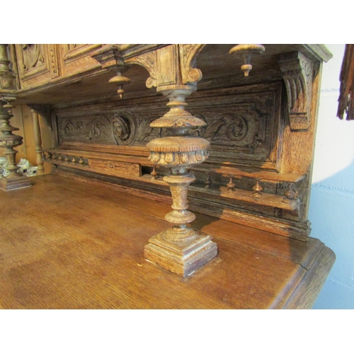 1007 - A carved oak 'Breton' style buffet with figural detail, masks and foliage, some losses, handle missi... 