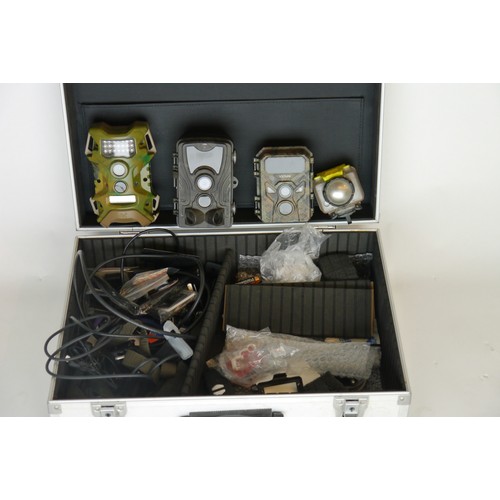 7092 - A alloy travel case containing a mix of Trail & Action cameras, comes with a mixture of accessories