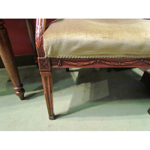 4002 - A Circa 1840 elm open armchair with green upholstery and carved decoration on square tapering reeded... 