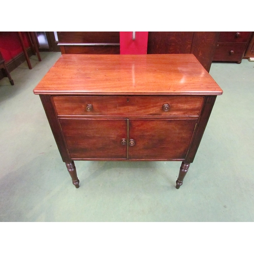 4076 - A George III mahogany side cabinet the single drawer over a two door cupboard on ring turned taperin... 