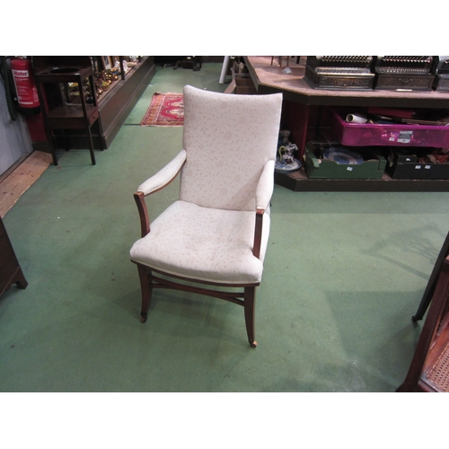 4210 - An Edwardian armchair, cream foliate design upholstery, on tapering legs to castors