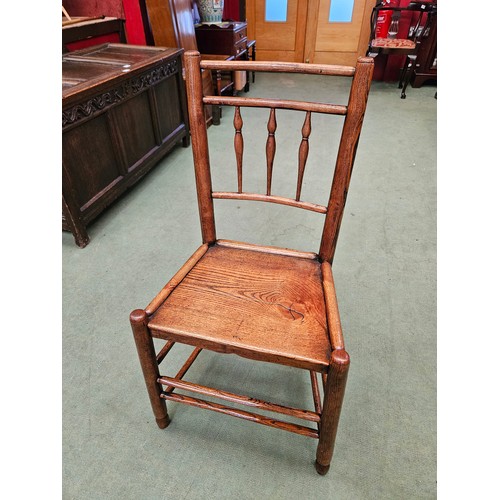 4212 - A Northwest 18th Century elm chair with turned spindle back rest over a flat seat