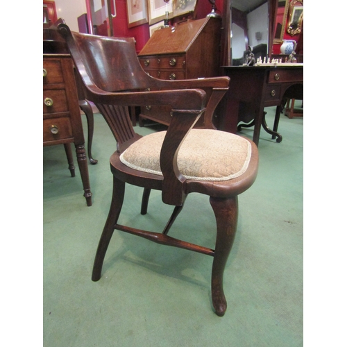 4213 - A circa 1900 oak desk chair, the scroll top backrest with fretwork, central splat over cabriole fore... 